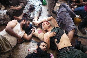 Partidarios heridos de Mursi permanecen en el piso de un hospital improvisado en el distrito cairota