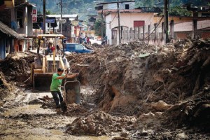 Con ayuda de maquinaria, habitantes de Paraso, a 8 km de La Pintada, retiran lodo de calles y vivie