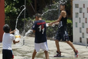 Nios y jvenes, principalmente, juegan entre s a arrojarse agua en calles de la colonia Guerrero, 